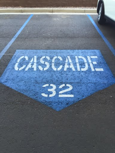 We Do Lines Arizona - A designated parking spot with the label "CASCADE 32" painted in white on a blue background, featuring precise line striping for clear demarcation.